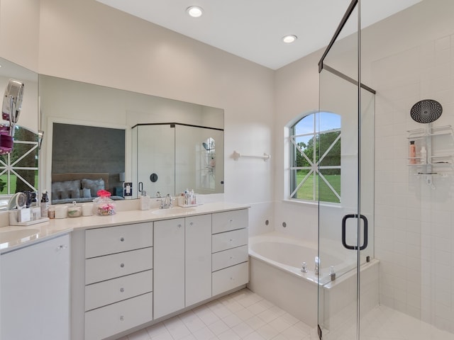 bathroom featuring tile patterned flooring, shower with separate bathtub, and vanity