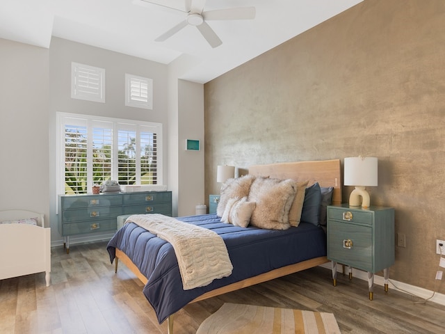 bedroom with ceiling fan and wood-type flooring