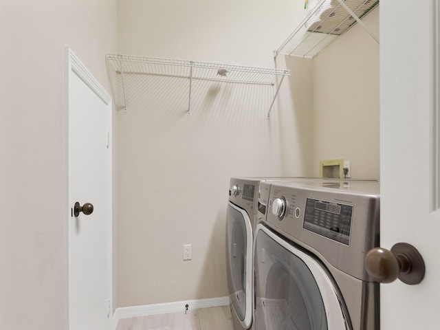 clothes washing area with washer and dryer