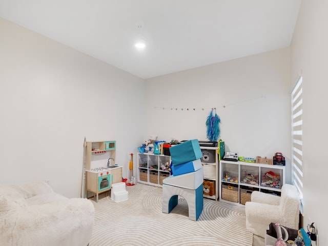 rec room with light colored carpet