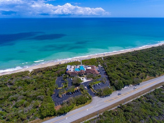 bird's eye view featuring a water view and a beach view