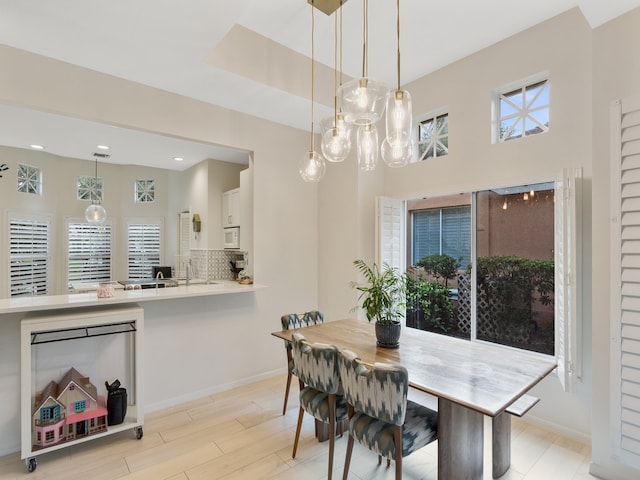 dining room featuring sink and light hardwood / wood-style floors