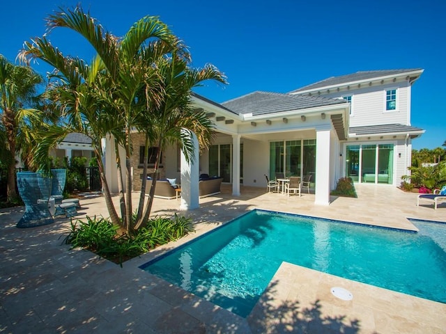 909 Surfsedge Way, Vero Beach, FL 32963 - back of property with a patio area, an outdoor pool, an outdoor living space, and a tile roof
