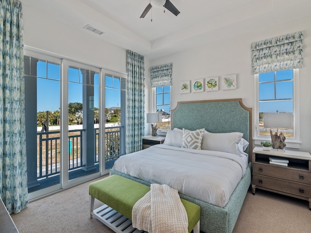 bedroom featuring ceiling fan, light carpet, and access to outside