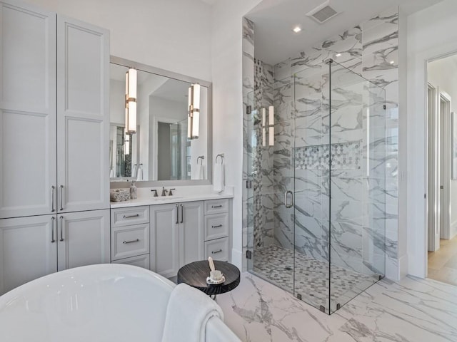 909 Surfsedge Way, Vero Beach, FL 32963 - full bathroom with a freestanding tub, a marble finish shower, vanity, marble finish flooring, and recessed lighting