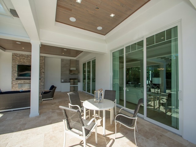 view of patio featuring an outdoor stone fireplace