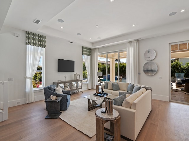 living room with plenty of natural light and light hardwood / wood-style flooring