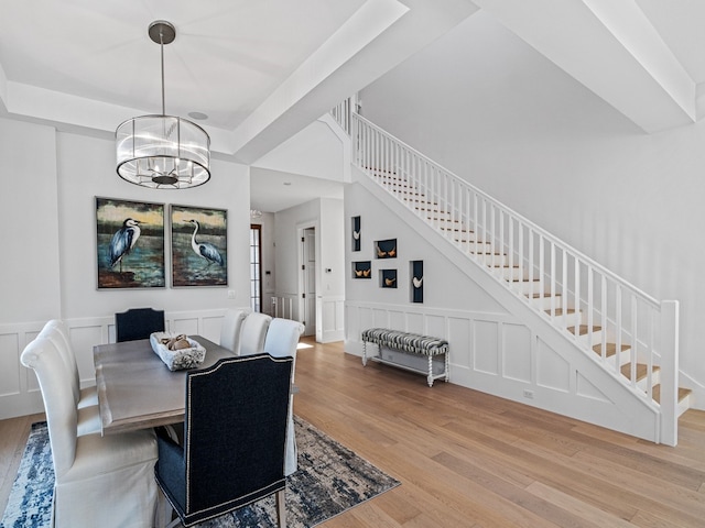 dining room featuring hardwood / wood-style floors and a chandelier