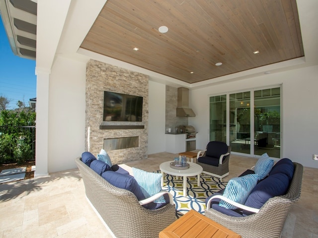 view of patio / terrace with an outdoor living space with a fireplace