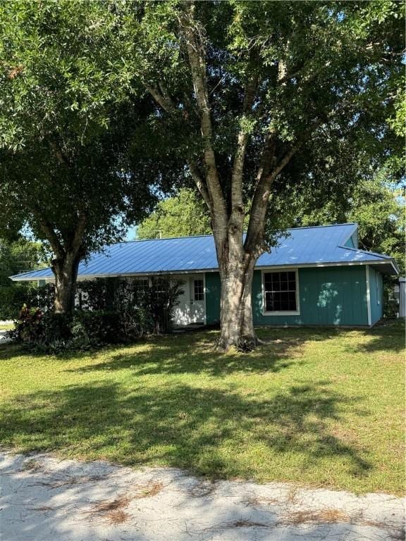 2380 89th Ave, Vero Beach, FL 32966 - ranch-style home featuring a front lawn and a metal roof