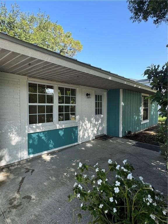 2380 89th Ave, Vero Beach, FL 32966 - view of home's exterior featuring a patio area and board and batten siding