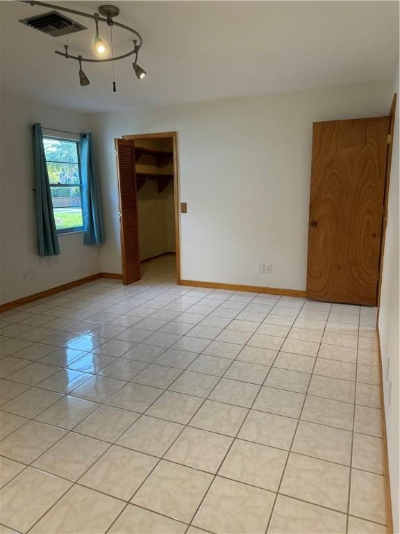 2380 89th Ave, Vero Beach, FL 32966 - empty room with light tile patterned floors and baseboards