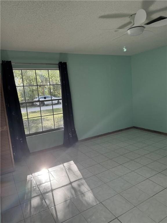 2380 89th Ave, Vero Beach, FL 32966 - unfurnished room with a textured ceiling, ceiling fan, and light tile patterned floors