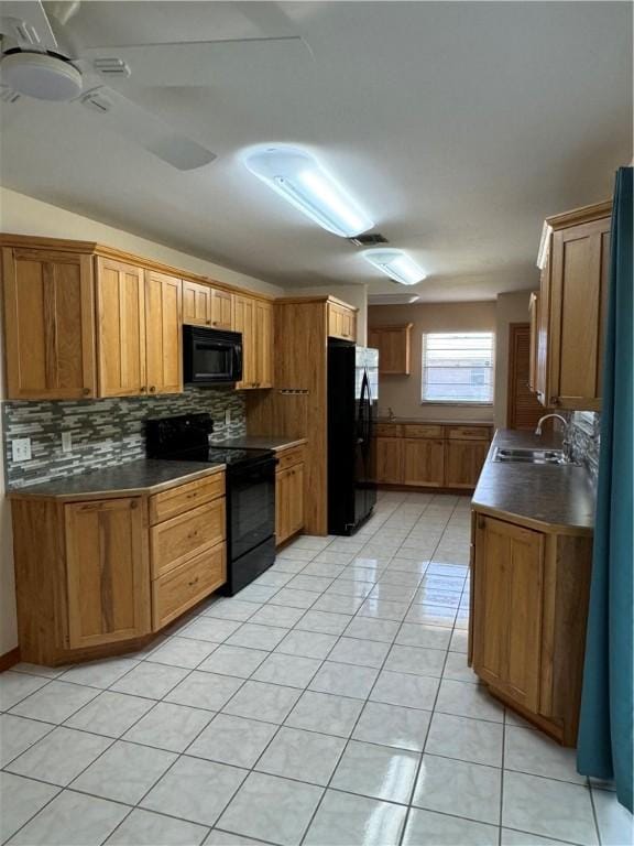 2380 89th Ave, Vero Beach, FL 32966 - kitchen with black appliances, decorative backsplash, dark countertops, brown cabinets, and light tile patterned flooring