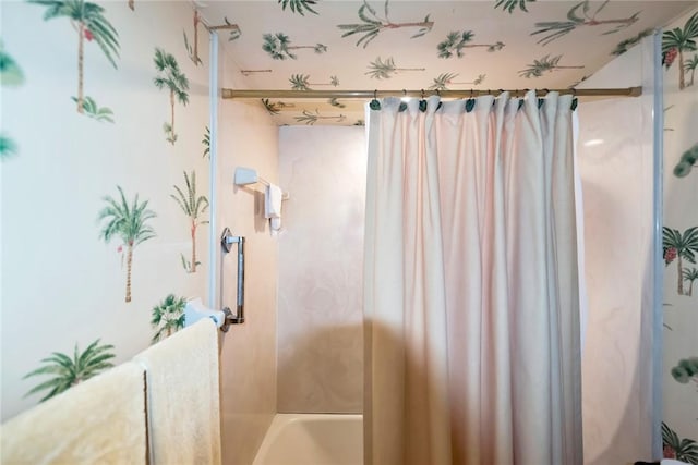 bathroom with shower / bath combo with shower curtain