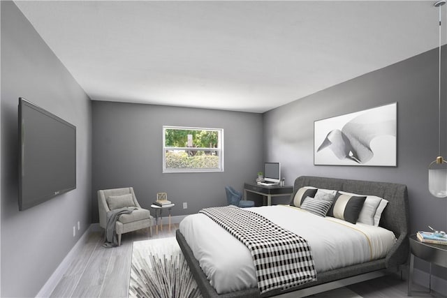 bedroom featuring baseboards and wood finished floors