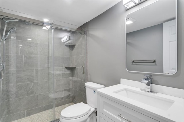 full bath featuring vanity, toilet, and a shower stall
