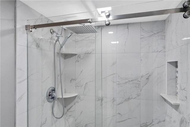 bathroom with a marble finish shower