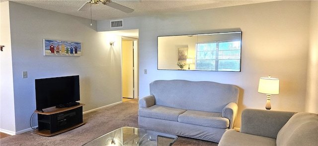 carpeted living room with ceiling fan and a textured ceiling