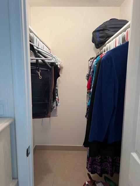 spacious closet with tile patterned flooring