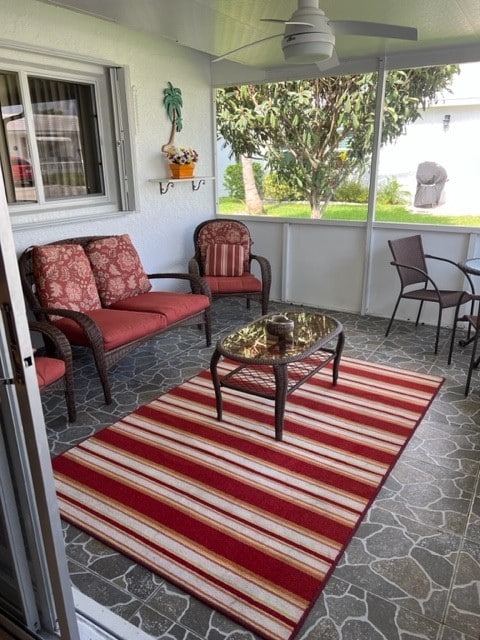 sunroom / solarium featuring ceiling fan