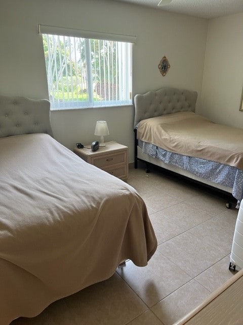 bedroom with light tile patterned floors