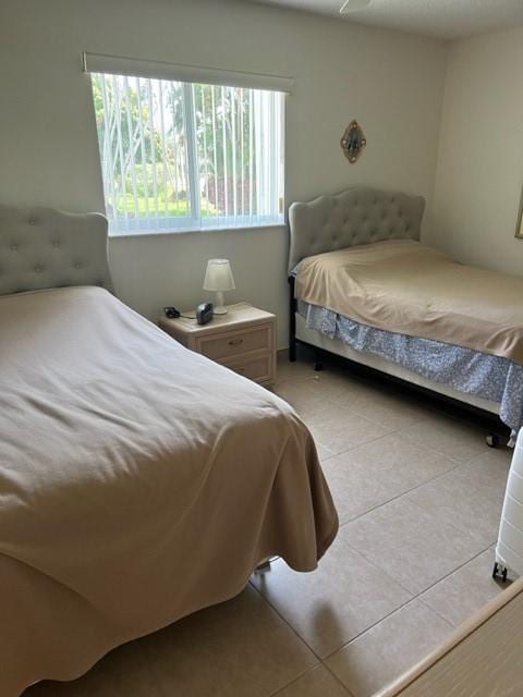 bedroom featuring light tile patterned floors