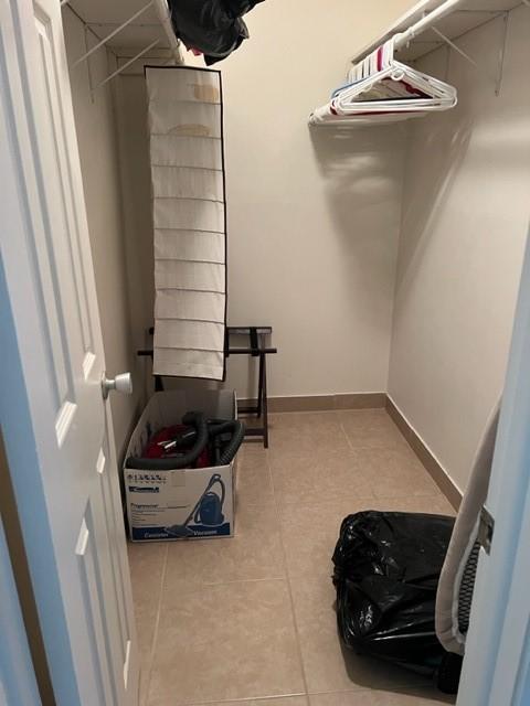 spacious closet featuring light tile patterned floors