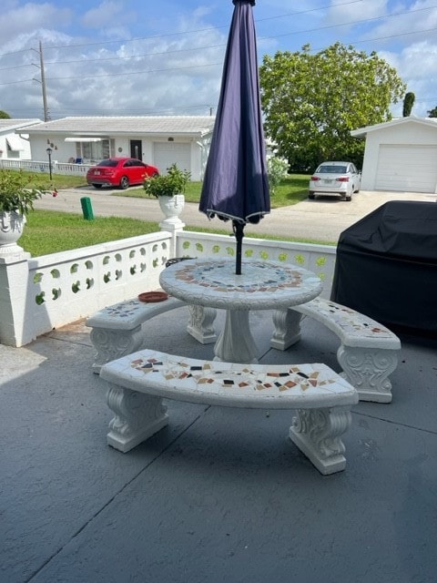 view of patio / terrace featuring a garage and area for grilling