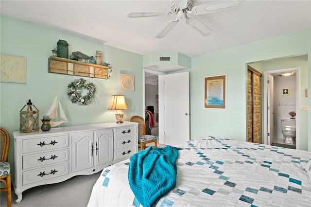 bedroom featuring a textured ceiling, carpet floors, ceiling fan, and connected bathroom