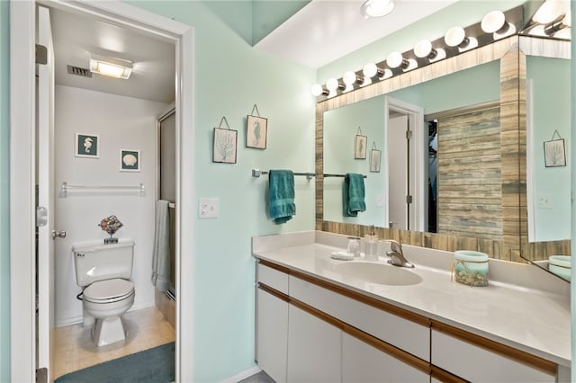 bathroom with walk in shower, tile patterned flooring, vanity, and toilet