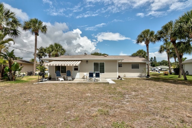 back of house with a yard and a patio area