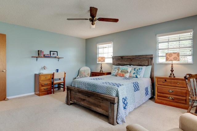 bedroom featuring carpet flooring, ceiling fan, and a textured ceiling