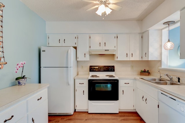 kitchen with pendant lighting, white cabinetry, white appliances, and sink