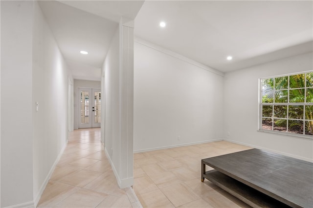 hallway featuring light tile patterned flooring and french doors