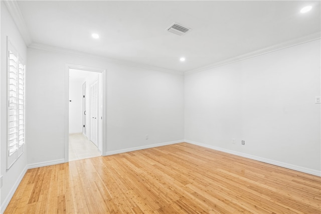 unfurnished room featuring light wood-type flooring and crown molding