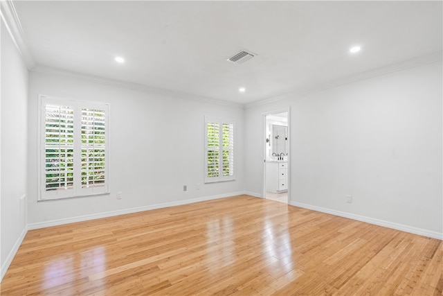 unfurnished room with light hardwood / wood-style flooring, a healthy amount of sunlight, and crown molding