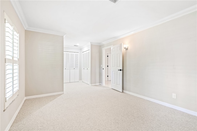 empty room featuring light carpet and ornamental molding