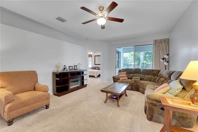 living room with ceiling fan and carpet flooring