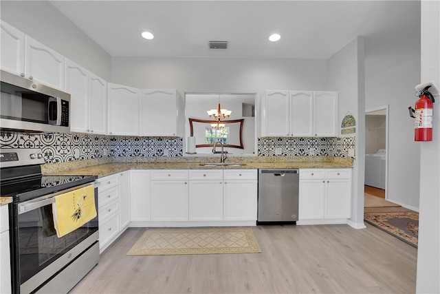 kitchen featuring white cabinetry, appliances with stainless steel finishes, light hardwood / wood-style floors, and sink