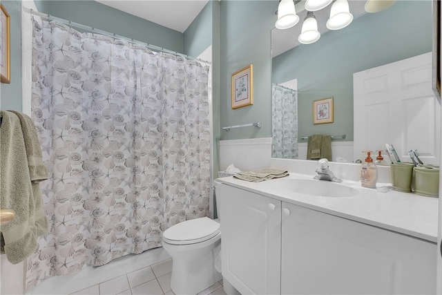 bathroom with tile patterned flooring, vanity, and toilet