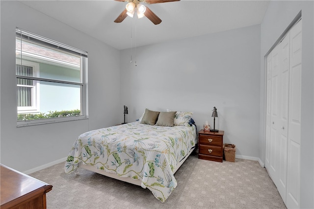 carpeted bedroom featuring a closet and ceiling fan