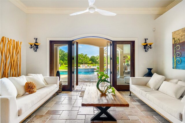 living room with ceiling fan and crown molding