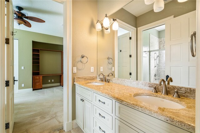 bathroom featuring walk in shower, ceiling fan, and vanity