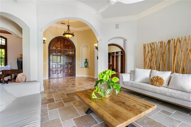 living room featuring ornamental molding and ceiling fan