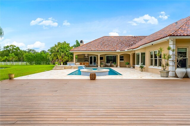 view of pool with a wooden deck, a patio, and an in ground hot tub