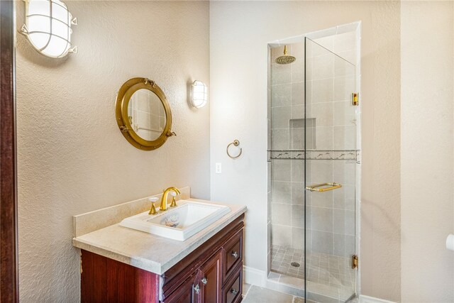 bathroom with tile patterned flooring, vanity, and an enclosed shower