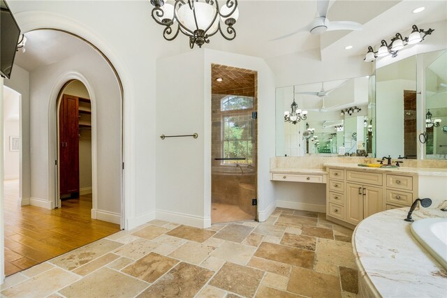 bathroom with vanity, plus walk in shower, wood-type flooring, and ceiling fan with notable chandelier