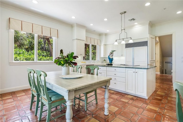 596 Ocean Rd, Vero Beach, FL 32963 - kitchen featuring backsplash, white cabinetry, recessed lighting, paneled built in refrigerator, and ornamental molding