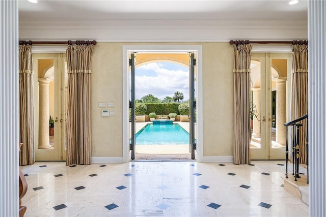 596 Ocean Rd, Vero Beach, FL 32963 - doorway to outside featuring french doors, crown molding, baseboards, and arched walkways